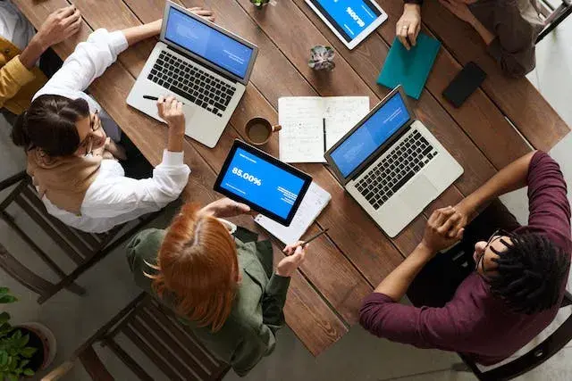 group-of-worker-gathered-using-their-computers-and-working